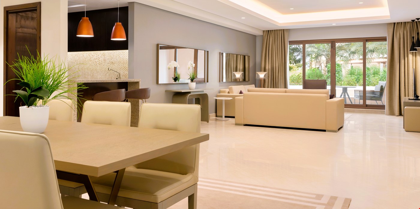 Hotel Dubai United Arab Emirates nomad remote a085bf0c-39eb-492c-b190-88b926db621a_FamilyThreeBedroomsGardenViewApartmentLivingandDiningRooma.jpg